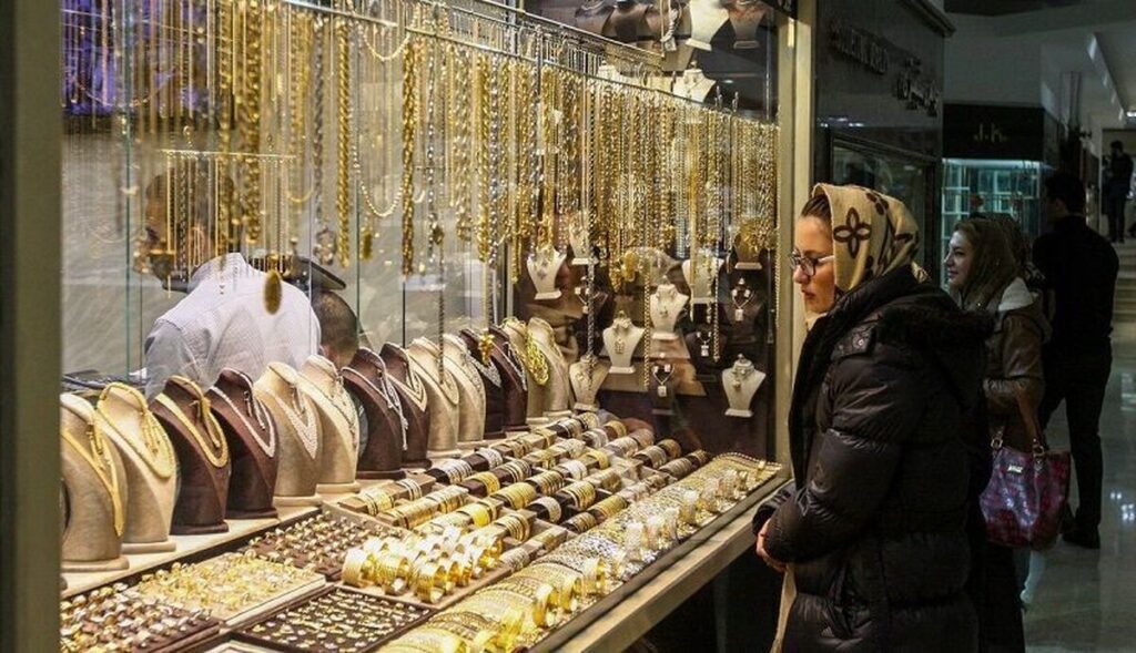 A woman looking at the window at a jewelry shop in Tehran